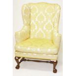 A MAHOGANY WING BACK LIBRARY ARMCHAIR, with padded back sides and cushion seat,