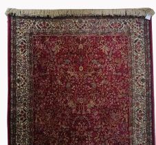 A KASHMIR STYLE BUGUNDY GROUND RUG, with all over tree of life design,