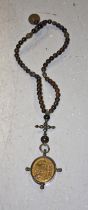 A VERY UNUSUAL 19TH CENTURY ROSARY BEADS, with silver parters,