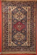 A KAZAK DESIGN RUG OR WALL HANGING, with two ivory and one red diamond shaped medallion,