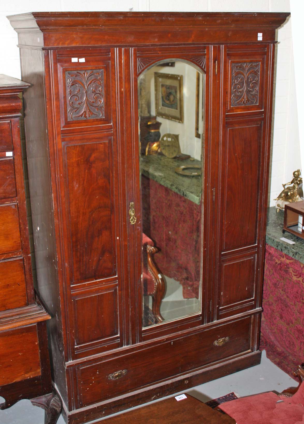 A WALNUT WARDROBE, early 20th century with moulded cornice and centre mirror door, 51in (130cm).