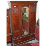 A WALNUT WARDROBE, early 20th century with moulded cornice and centre mirror door, 51in (130cm).