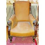 A LATE VICTORIAN LIBRARY ARMCHAIR, with padded back, seat and arm panels,