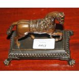 A LATE 19TH CENTURY BRONZED DESK ORNAMENT, in the form of a saddle horse,