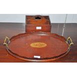 AN OVAL INLAID MAHOGANY TRAY WITH TWO BRASS HANDLES, on a wavy gallery,