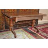 A VICTORIAN MAHOGANY LIBRARY TABLE, the rectangular top on a pair of baluster turned stems,