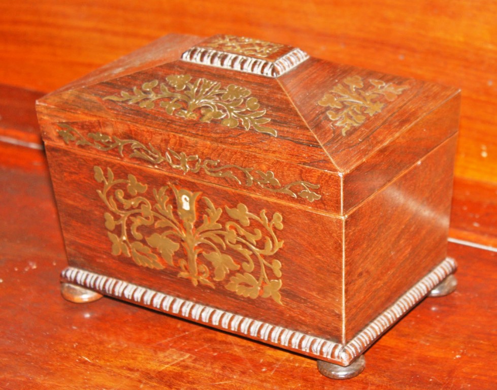 A REGENCY PERIOD BRASS INLAID ROSEWOOD TEA CADDY, of sarcophagus form, with divided interior,