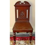 A PAIR OF EDWARDIAN MAHOGANY HALL CHAIRS, each with solid seat, raised on tapering legs.
