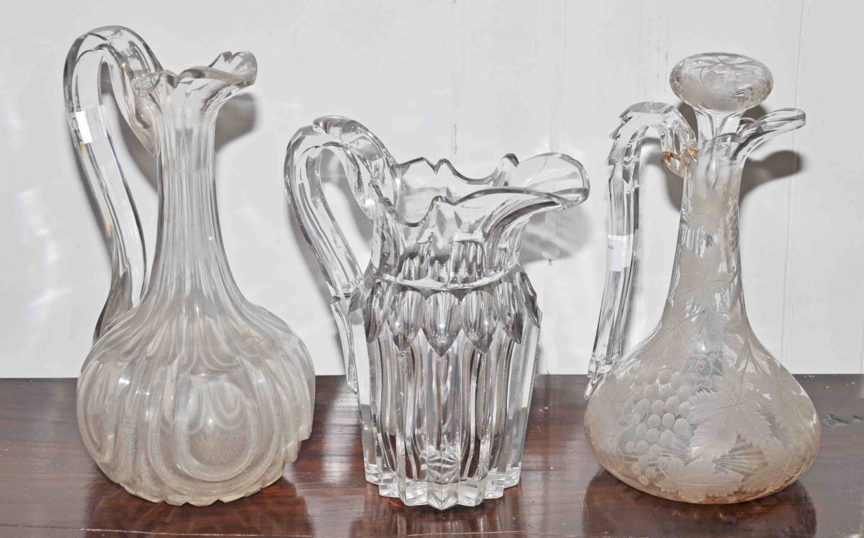 A 19TH CENTURY CUT GLASS WATER JUG, 9" (23cm); together with a 19th century cut glass claret jug,