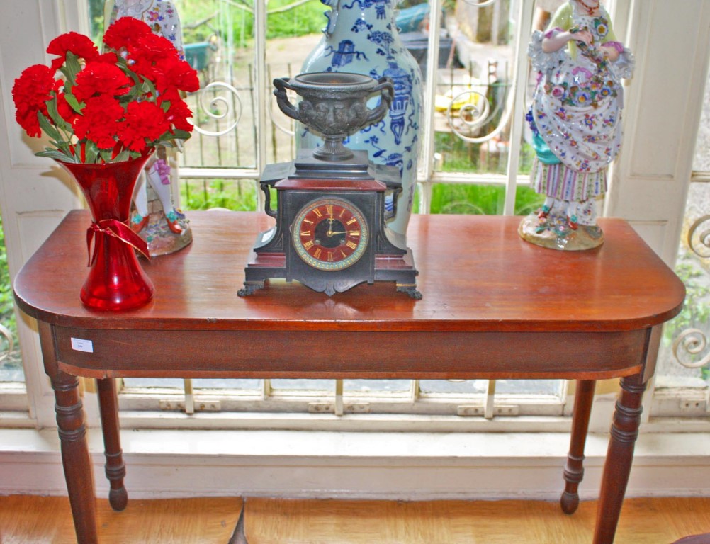 A MAHOGANY GEORGE IV SIDE TABLE, with the D shaped top raised on ring turned legs, 46" (117cms),