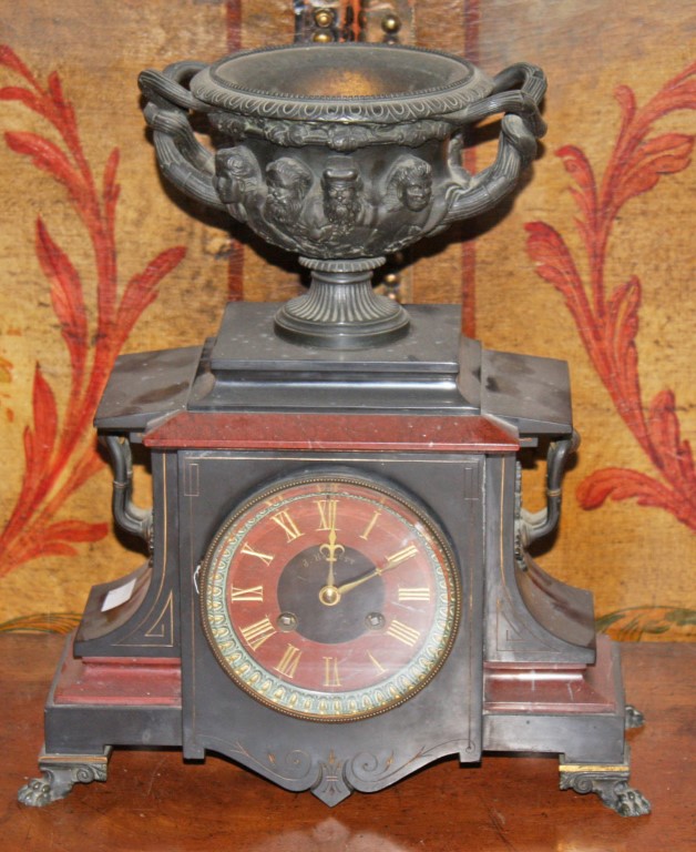 A POLISHED LIMESTONE AND ROUGE MARBLE MANTEL CLOCK, the rouge and black marble dial signed J.F.