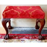 A MAHOGANY CHIPPENDALE STYLE RECTANGULAR STOOL with padded seat on four cabriole legs on ball n'
