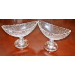 A PAIR OF WATERFORD CRYSTAL CANOE SHAPED CUT-GLASS STEMMED BOWLS, each on circular foot,