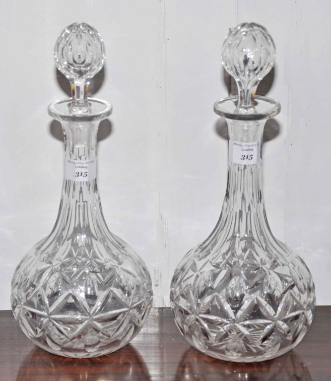 A GOOD HEAVY PAIR OF LATE 19TH CENTURY CUT GLASS DECANTERS AND STOPPERS, each of bottle form,