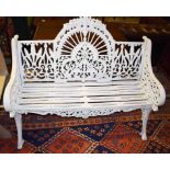 A HEAVY PAINTED CAST IRON GARDEN BENCH, with arched and pierced back,
