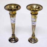 A PAIR OF BIRMINGHAM SILVER TRUMPET SHAPED VASES, each with weighted base, 8" (20cm).