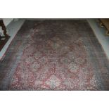 A LARGE ORIENTAL FAWN GROUND CARPET, with centre medallion, on an all over floral field,