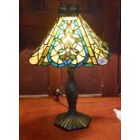 A TIFFANY STYLE BRONZED, COLOURED AND LEADED GLASS TABLE LAMP, with square flared shade,