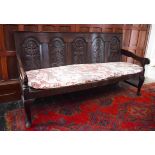 A 17TH CENTURY STYLE OAK HALL BENCH, the back with four leaf and flower carved arched panels,