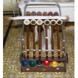 A MODERN FORSTER LONG CROQUET SET, with five balls, six mallets, on a small tubular trolley.