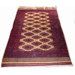 A BOKHARA RUG, the ivory field with rows of octagons inside a multi-band border,