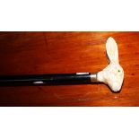 AN EBONIZED WALKING STICK, with composition faux ivory rabbit head handle.