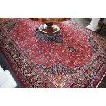 A PERSIAN MASHAD CARPET, with centre blue floral medallion,
