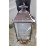 A SQUARE COPPER STREET OR YARD LANTERN, with four glazed panels and shaped top finial, 31" (79cm).