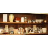 TWO SHELVES OF MISCELLANEOUS POTTERY, comprising jardinieres vases candle sticks, tableware,