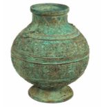 A CHINESE BRONZE URN, with all over floral pattern, on stem base, 12.75" (33cm).