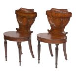 A FINE PAIR OF GEORGE IV PERIOD MAHOGANY SHIELD-BACK HALL CHAIRS, each with a reeded scroll crest,