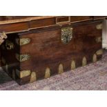 A VERY LARGE HEAVY 18TH CENTURY BRASS BOUND MAHOGANY TRUNK, with ornate brass strap-work hinges,