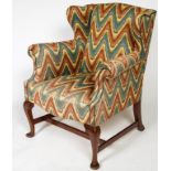 A LARGE WING BACK LIBRARY ARMCHAIR, in the 18th century style,