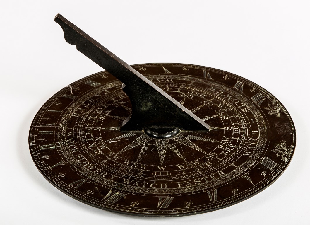 A CIRCULAR BRONZE SUNDIAL, with engraved bands, with the months of the year,