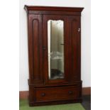 A VICTORIAN MAHOGANY WARDROBE, the moulded cornice above a central mirror door,