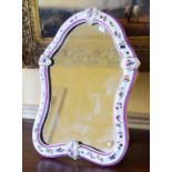 A CONTINENTAL PORCELAIN CARTOUCHE SHAPED TABLE MIRROR,