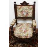 A 19TH CENTURY X-FRAMED STAINED AND CARVED OAK THRONE CHAIR, the padded back above a padded seat,
