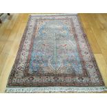 A TURKISH RUG, the light blue field with " Tree of Life Design", inside an ivory border,