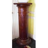 A MAHOGANY PEDESTAL WITH SQUARE SWIVEL TOP, raised on a turned and fluted cylindrical stem,