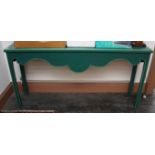 A TALL MODERN GREEN PAINTED SIDE TABLE, with oblong moulded top above a shaped frieze,