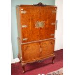 A NICELY FIGURED WALNUT COCKTAIL CABINET,