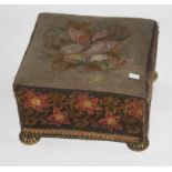A VICTORIAN SQUARE TAPESTRY COVERED FOOT STOOL, on four reeded brass bun feet, 14" (35cm)sq.