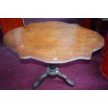 A 19TH CENTURY CONTINENTAL WALNUT CENTRE TABLE, with serpentine shaped top,