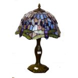 A TIFFANY STYLE BRONZED TABLE LAMP, with coloured and metal glazed shade, 17" (43cm)h.