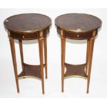 AN ATTRACTIVE PAIR OF CIRCULAR WALNUT AND BRASS MOUNTED TWO TIER ÉTAGÈRES, O.R.M.