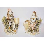 A PAIR OF GERMAN PORCELAIN FIGURES, one with a man seated holding a pale,