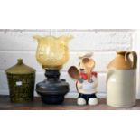 A MISCELLANEOUS COLLECTION OF KITCHEN ORNAMENTS, including an old oil lamp, a stoneware spirit jar,