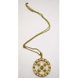 A 9K GOLD WHEEL PENDANT, with central peri dot on a grid,