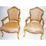 A PAIR OF FRENCH GILT FAUTEUILS, each cartouche shaped padded back with a floral crest,