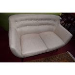 A MODERN DESIGNER STYLE TWO SEATER SETTEE, covered in oatmeal fabric,